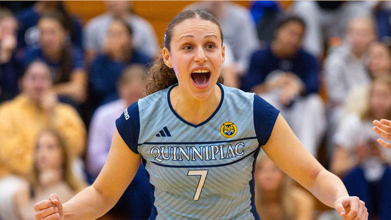 Volleyball player screams in excitement.