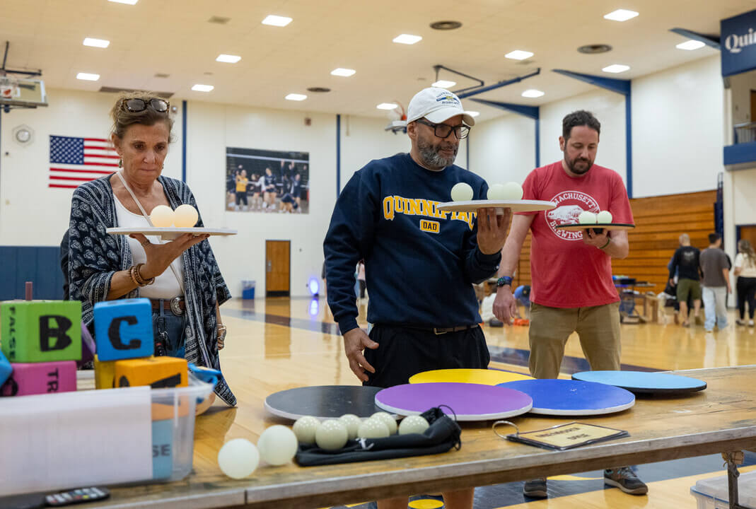 Families can be seen playing a balancing game