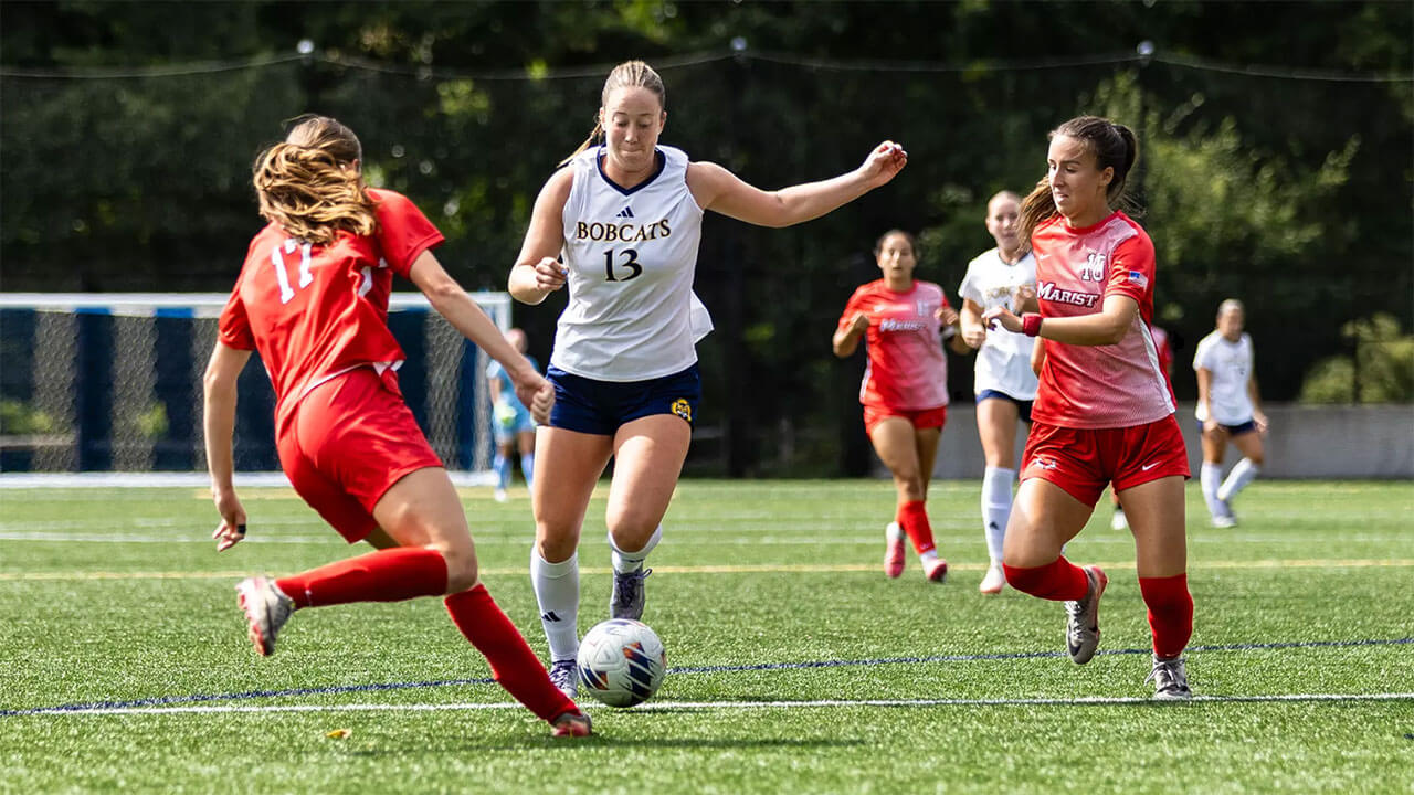 Quinnipiac soccer player steals ball from another team.