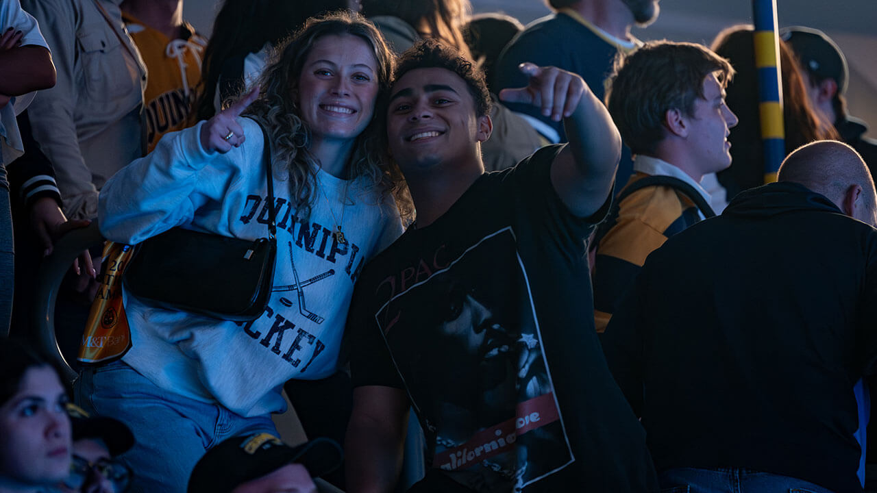 Two hockey fans smile for a photo