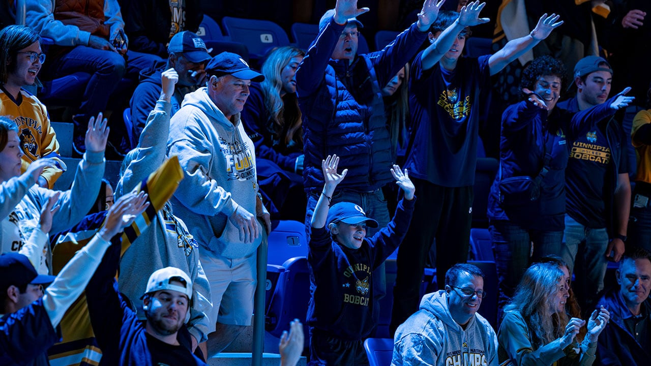 Bobcats put their hands in the air to cheer