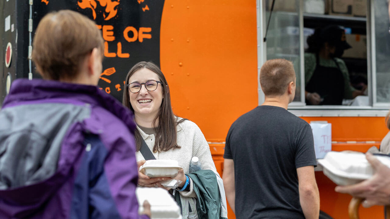 Parents and students smiling at food truck