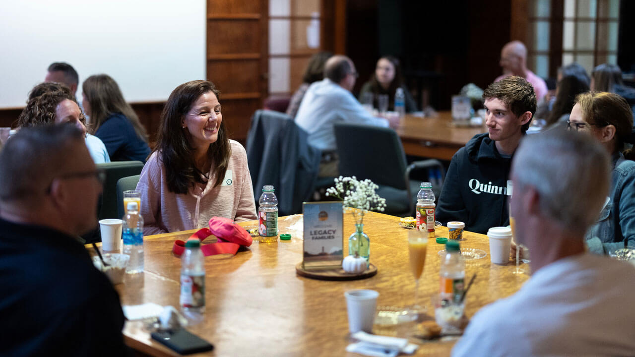 Parents and students talking during brunch