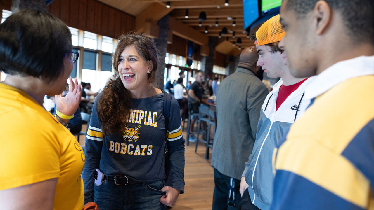 Alumni and families talk during a reception hosted at On the Rocks Pub and Grill