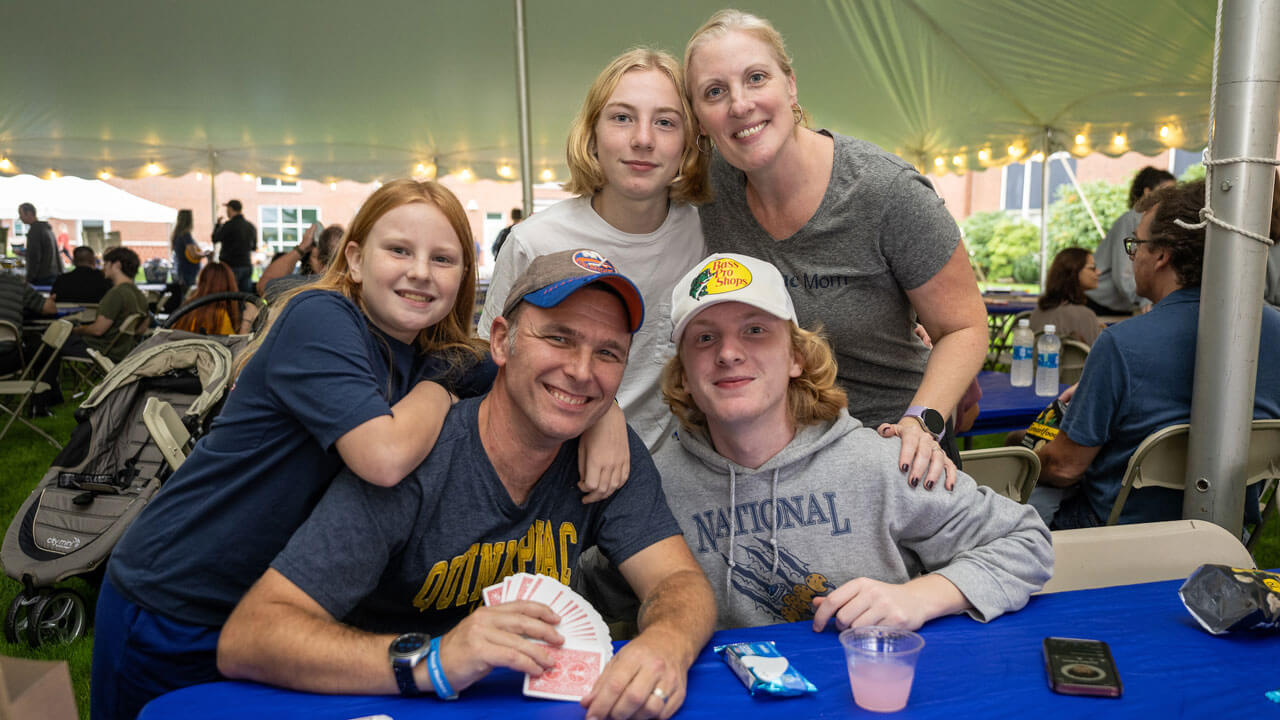 Family hurdle in for a group photo wearing Quinnipiac National Champion apparel