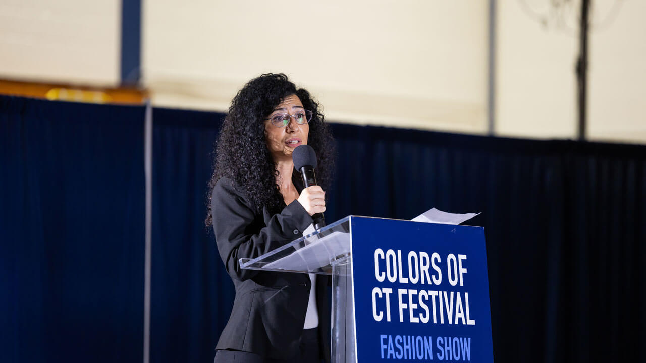 Co-Director of M&T Bank Center for Women & Business, Tuvana Rua speaks at the Colors of Connecticut festival.