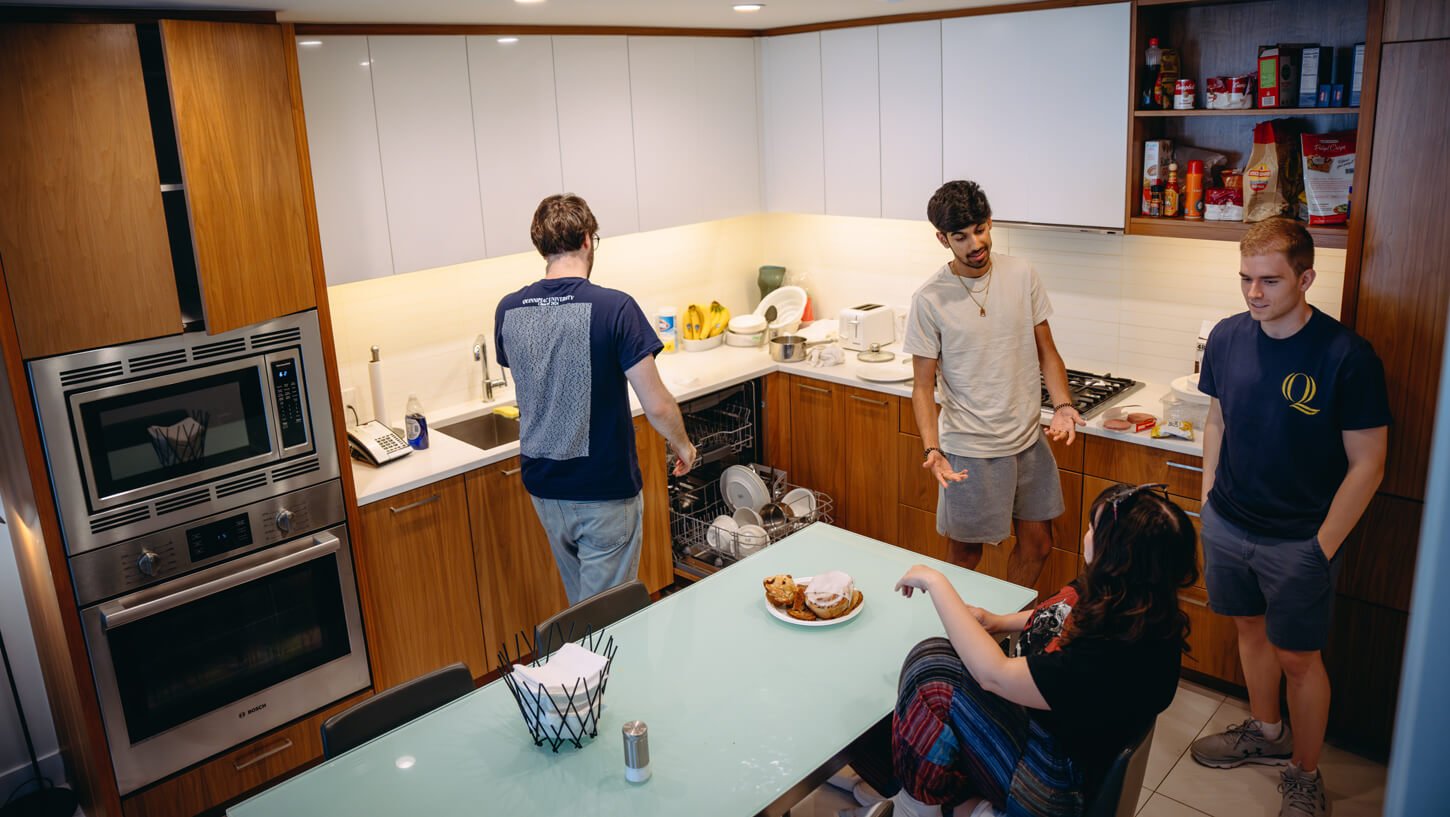 Students utilize the kitchen amenities in their suite.