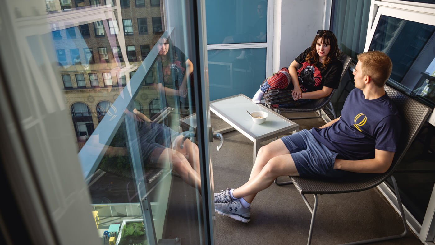 Students sitting on the open-air balcony at their hotel in Los Angeles