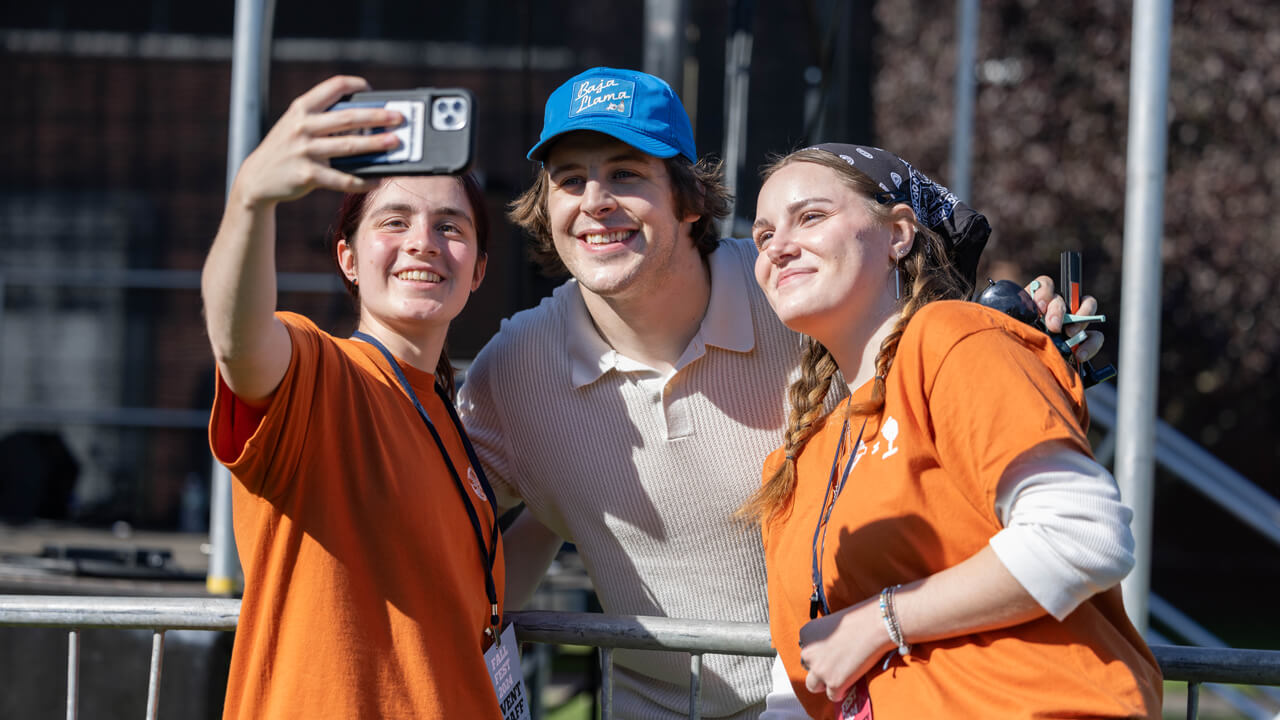 People take a selfie with the performer