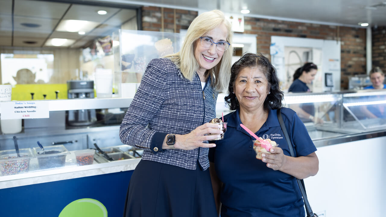 Marie Hardin poses with a staff member as they eat ice cream at Wentworth's