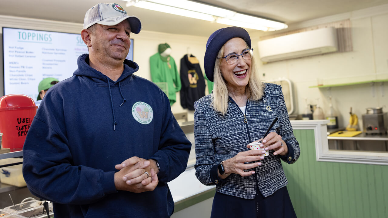 Marie Hardin laughs with a Wentworth's staff member as she holds an ice cream cup
