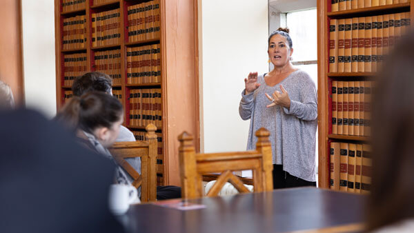 A woman speaking to a group in a library