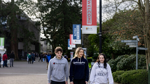 3 students walking outside at UCC