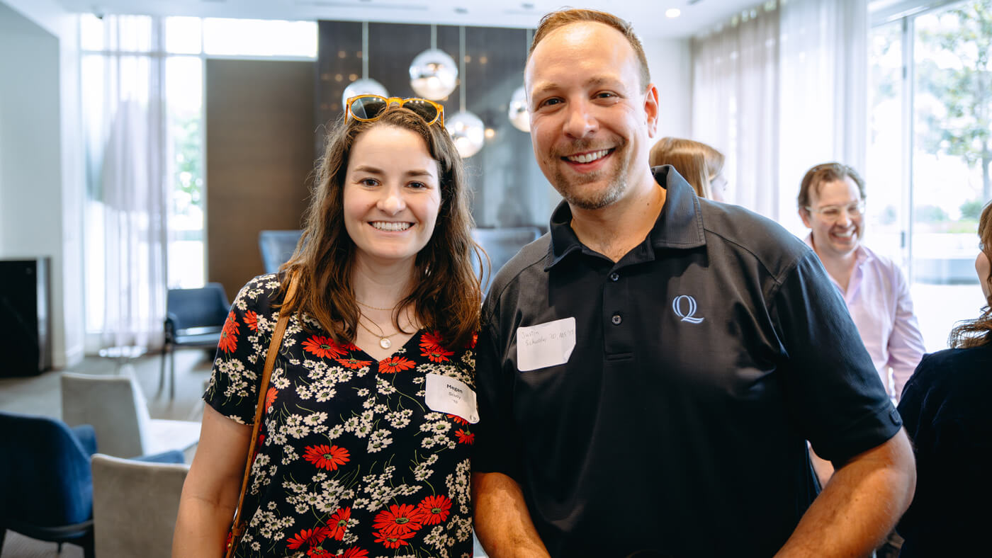 Two Quinnipiac University School of Communications alumni pose for a photo.