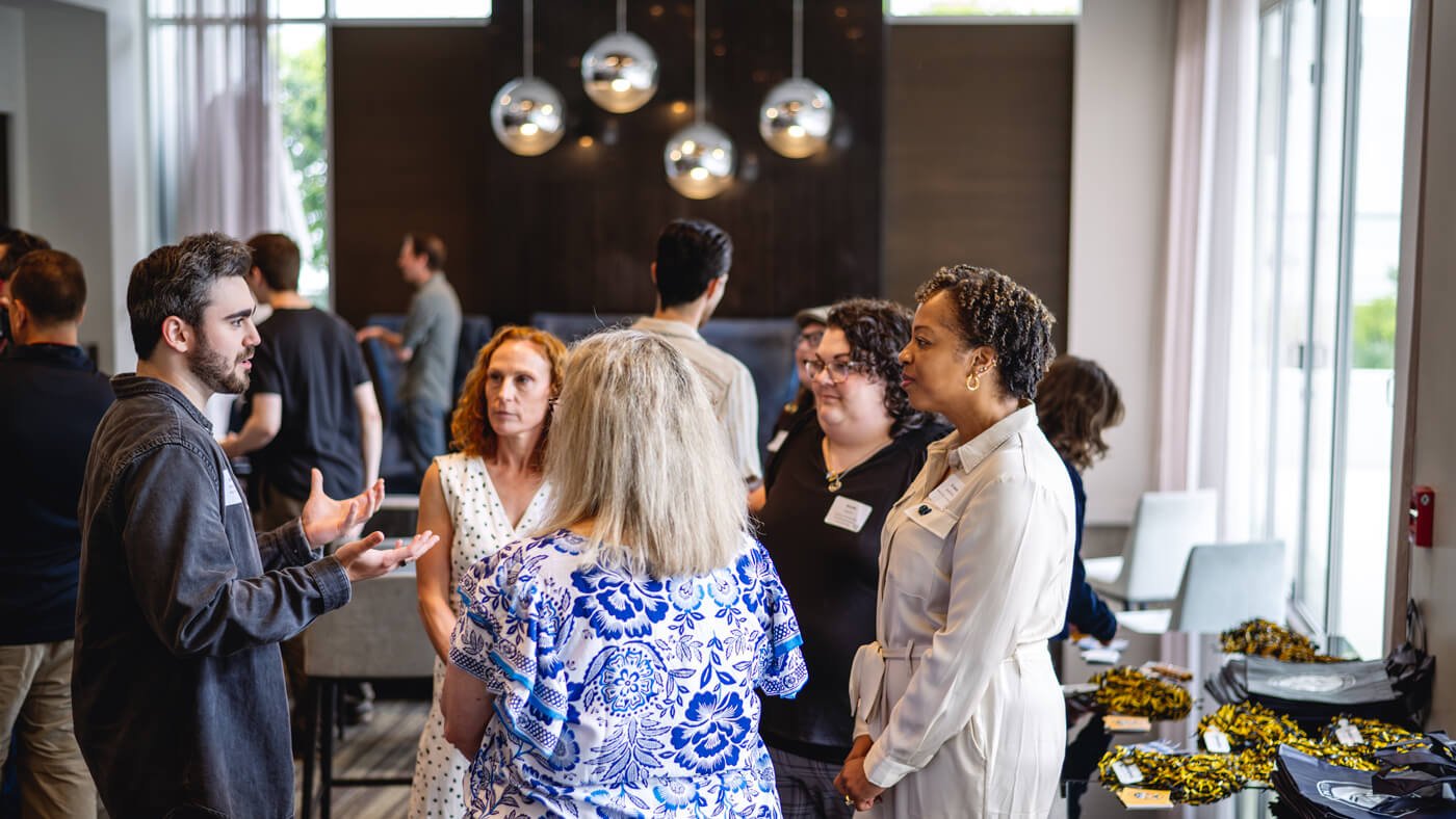 Quinnipiac University School of Communications alumni converse with each other and current faculty members at the gathering.