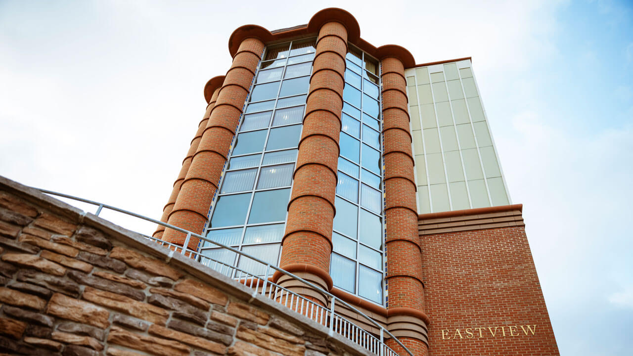 A view of Eastview residence hall with a clear blue sky