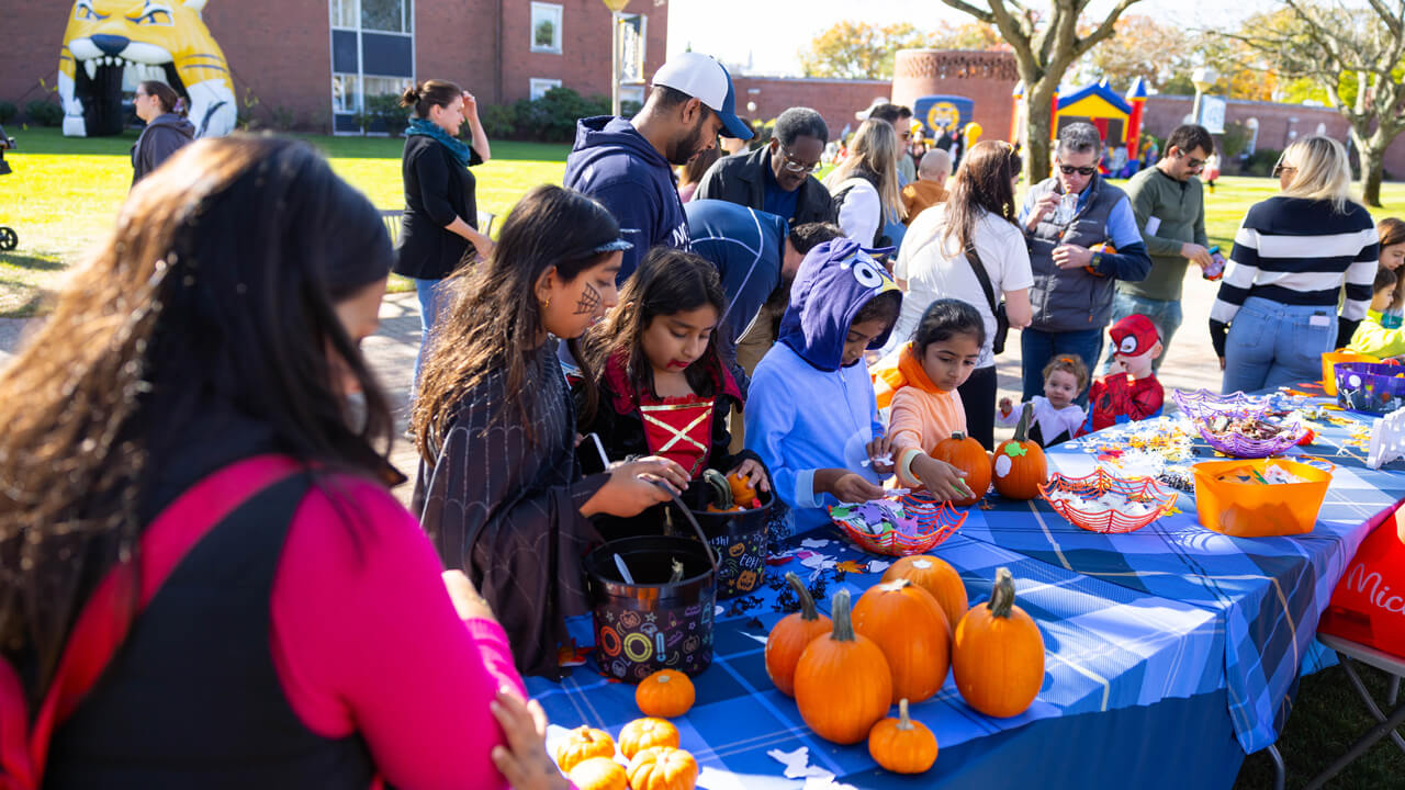 People pick pumpkins from a table