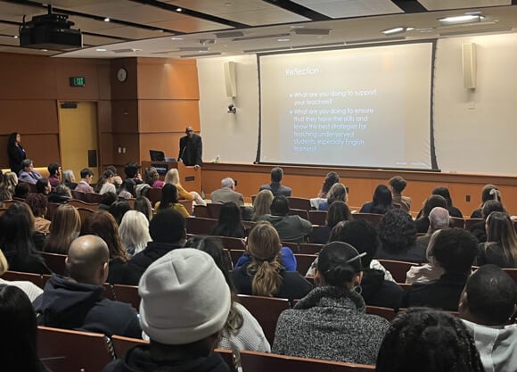 People sit in an auditorium