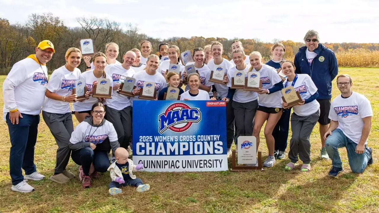 Quinnipiac women's cross country team members and coaches pose after winning MAAC championships