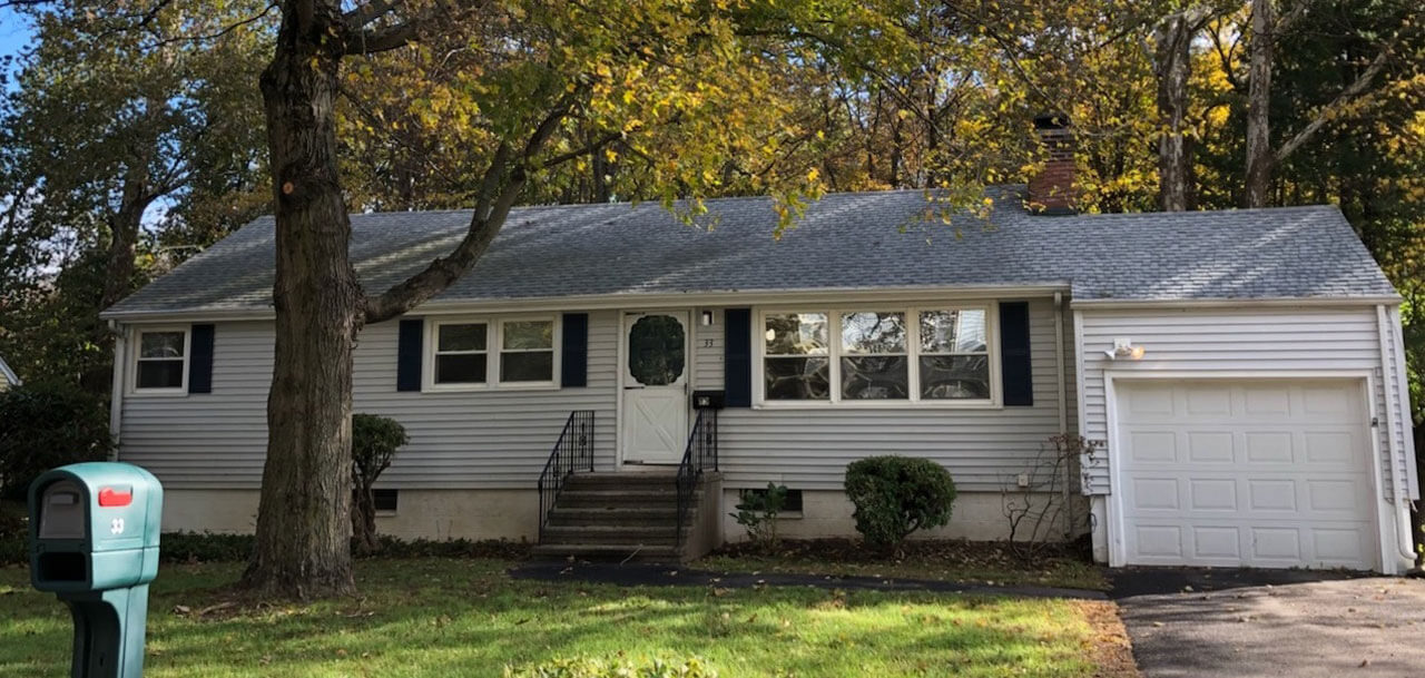 White ranch with one car garage on 33 New Road