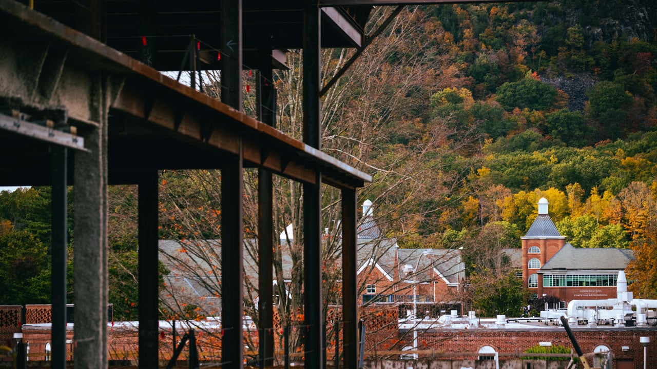 Beams and parts of buildings at a construction site against the fall landscape.