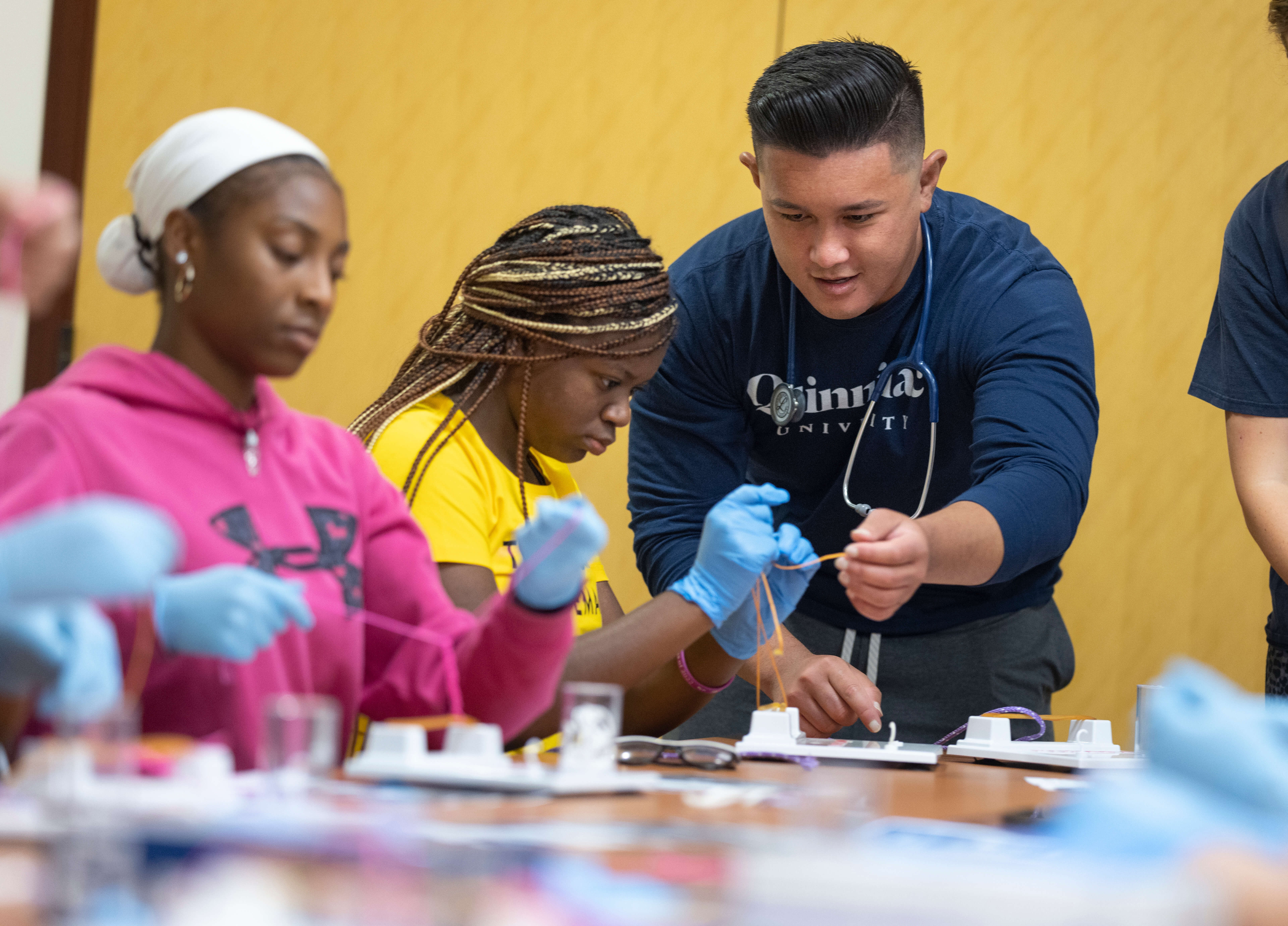 Quinnipiac student helping summer program participants