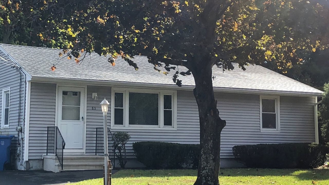 Grey house with lamp post on the right side on 83 New Road