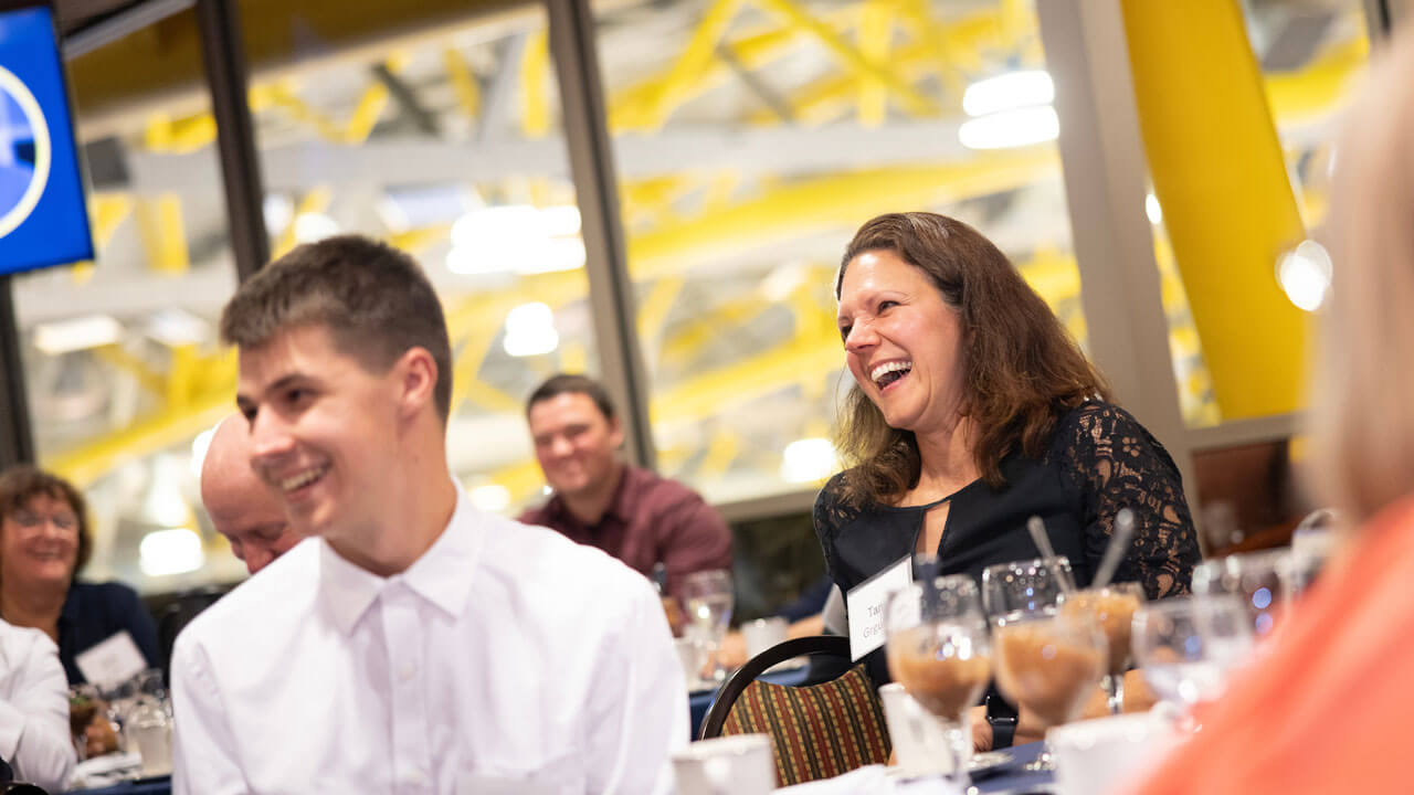 Family smiling and laughing at table