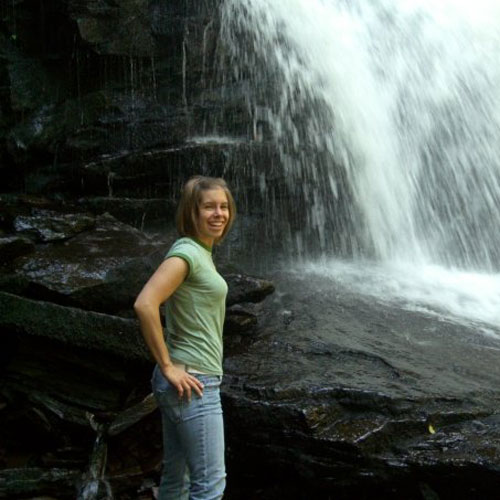 Charity Kuchyt standing in front of a waterfall