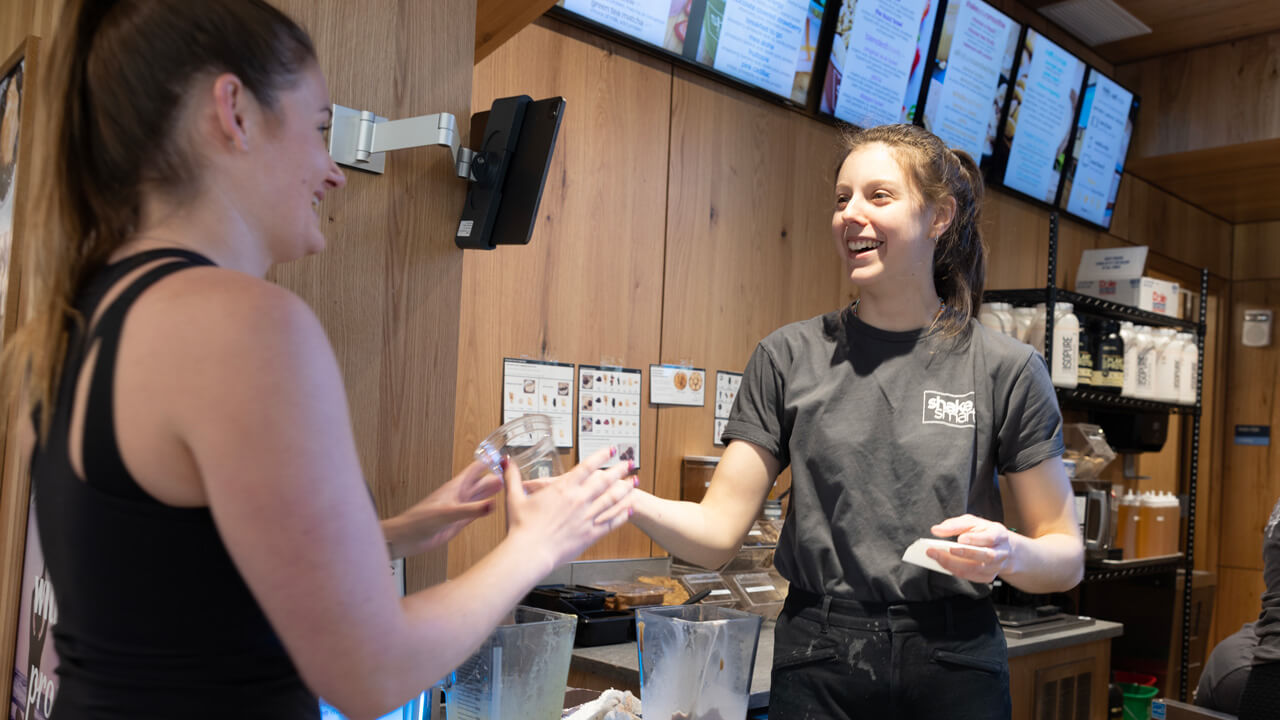 A Shake Smart employee taking payment