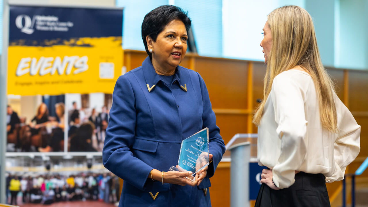 indra nooyi talks with fireside chat attendee as she recieves her award