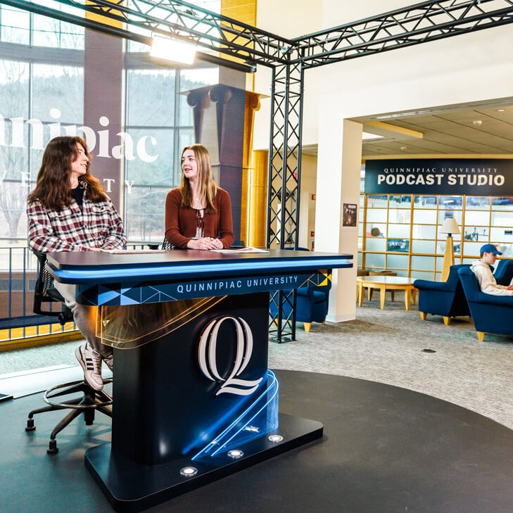 Students broadcasting from an open air studio in the School of Communications