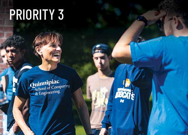 Priority 3: An engineering faculty member interacts with students during a bottle rocket launch outside