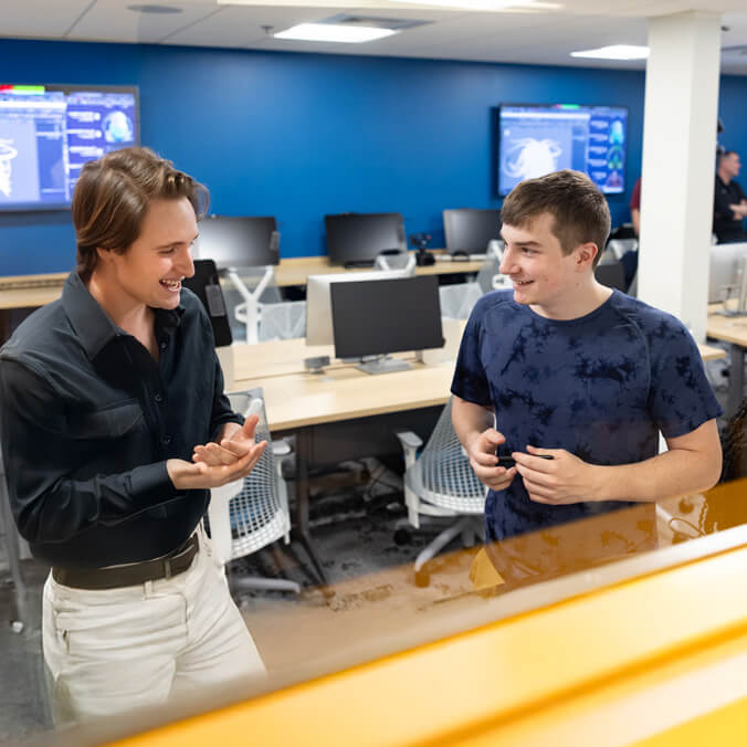 Students collaborate in a computer lab.