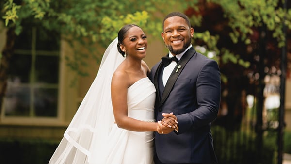 Asia (Skyers) Sumner and Bryan Sumner smile and hold hands on their wedding day