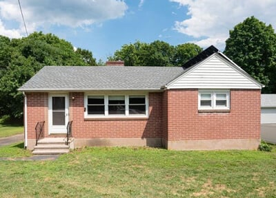 One-story red-brick house on sunny day on 17 New Road