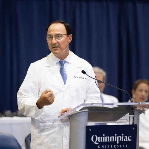 Photo of the Dean of the School of Medicine, Phil Boiselle, speaking at a podium.