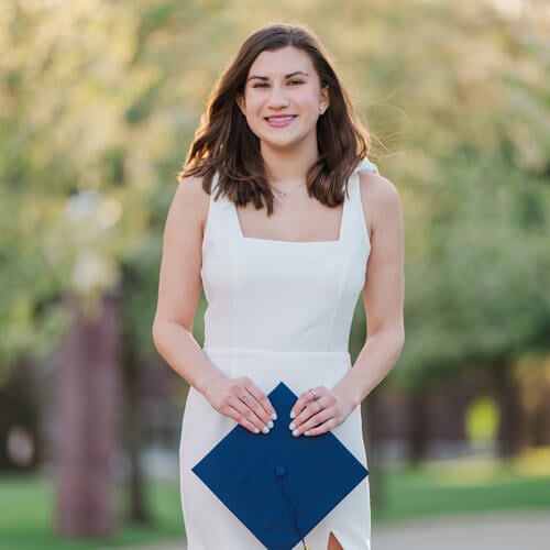 Jacqueline Ydrovo holding graduation cap