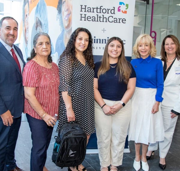 Quinnipiac and Hartford HealthCare leaders pose for a photo with MoonCatcher Project volunteers