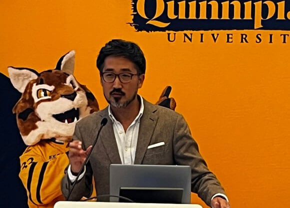 Jason Koo speaking to an audience