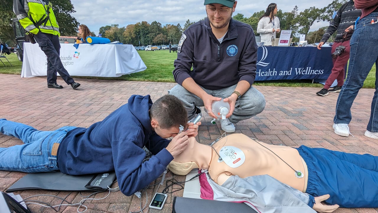 Two students learning how to intubate on a dummy