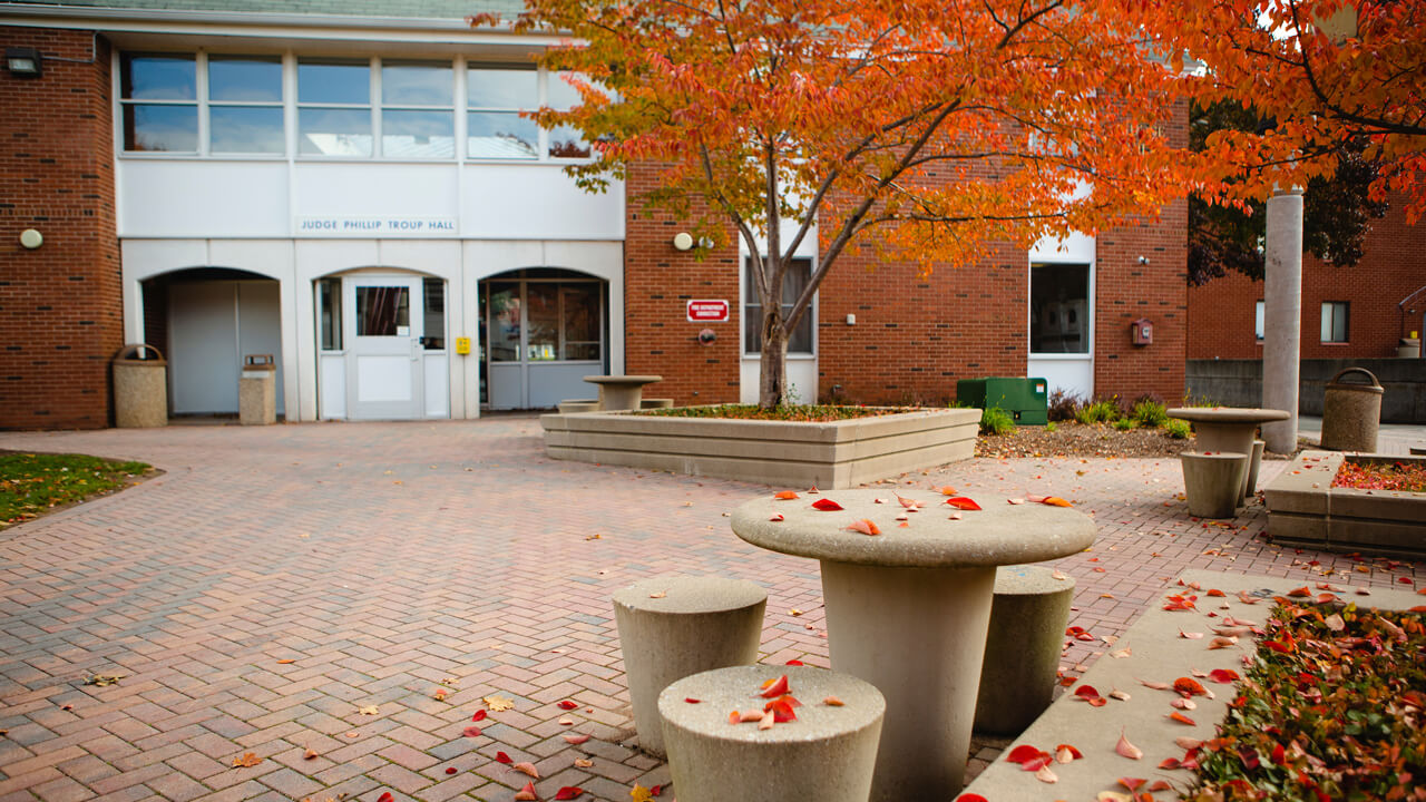 Entrance and courtyard outside Troup residence hall on a fall day