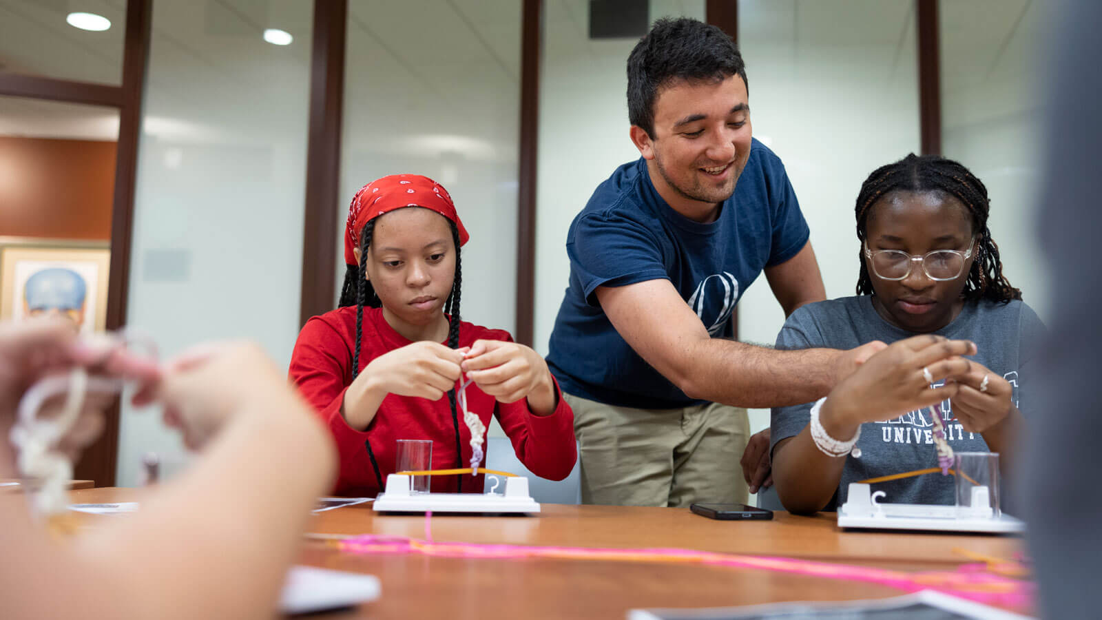 High school students work with a Quinnipiac professor and students during a health exploration camp.