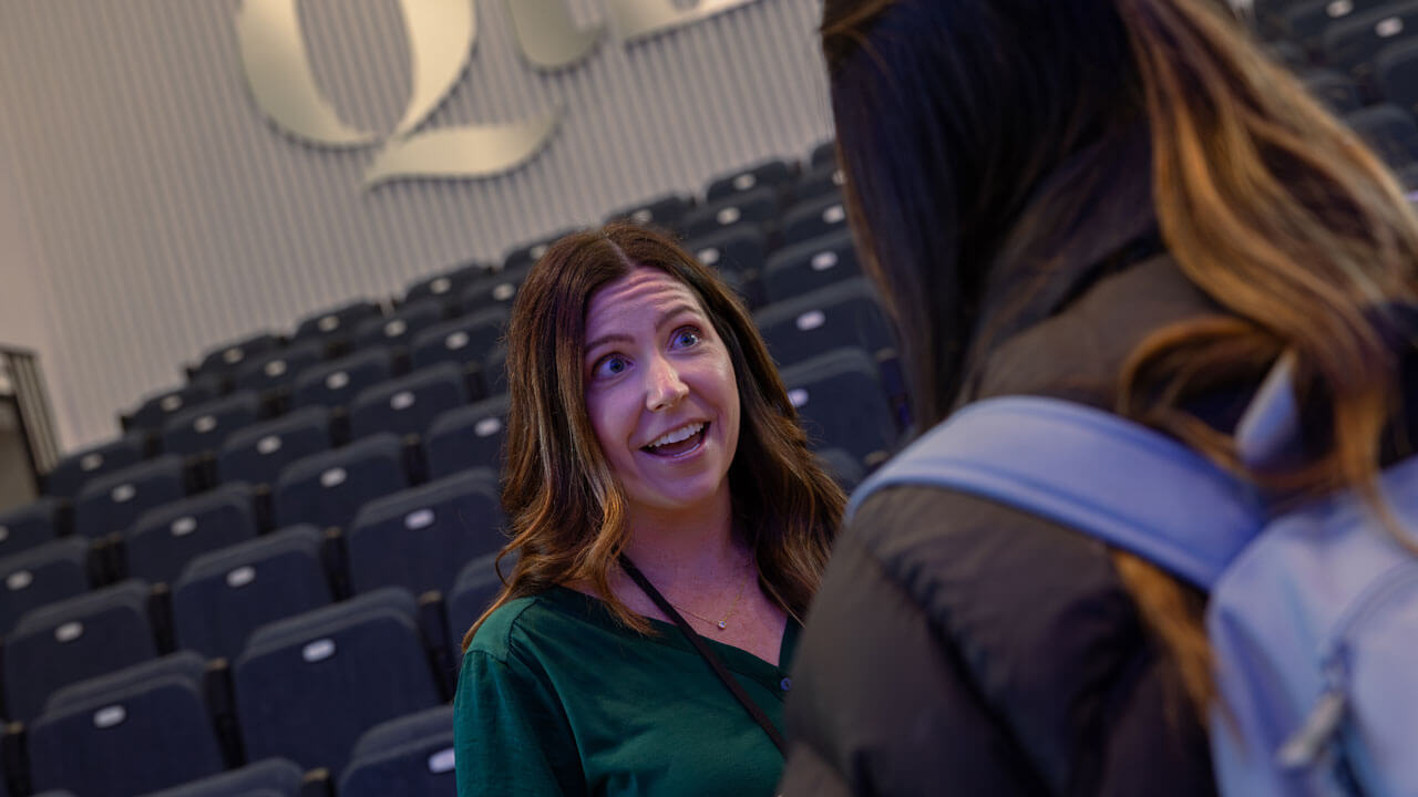 a Boehringer Ingelheim panelist speaker talks to a student