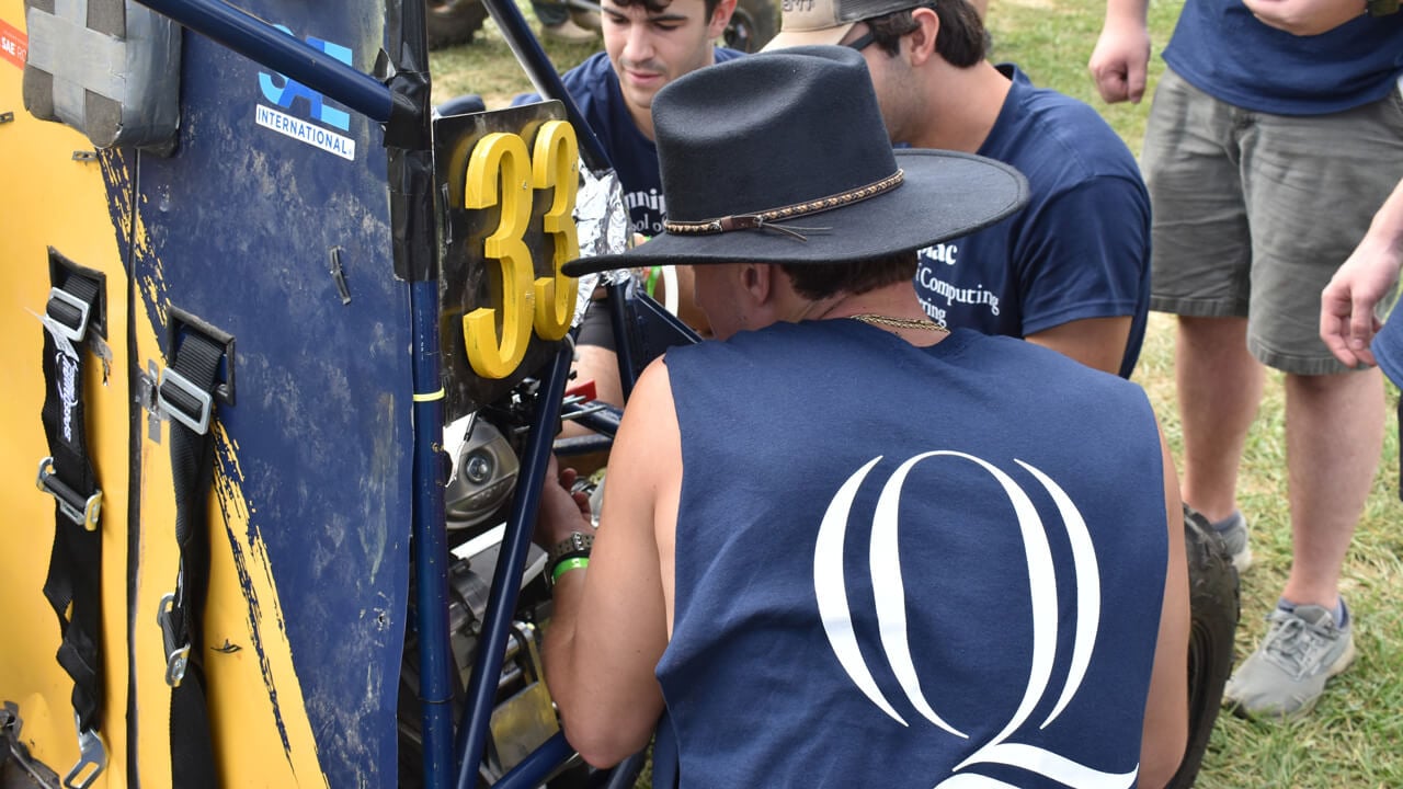 2 students working on the Baja vehicle