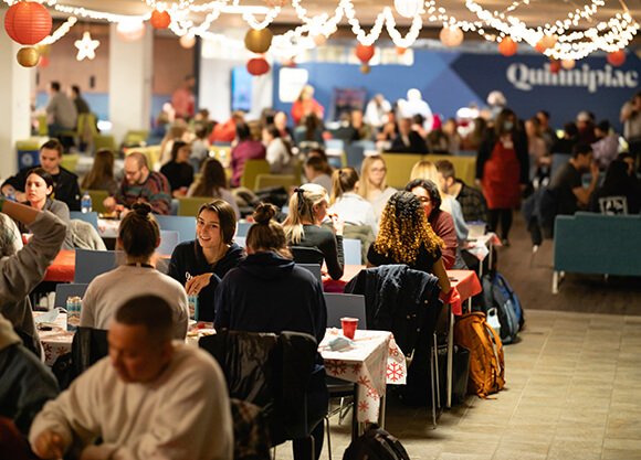 Graduate students participate in a traditional holiday dinner.