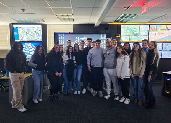 Students smile in front of tons of technology at Hartford's C4 Center