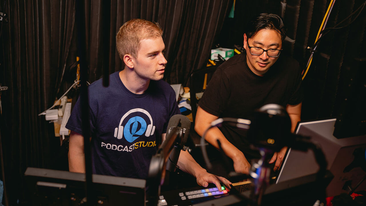 Student at the sound board in the School of Communications Podcast Studio