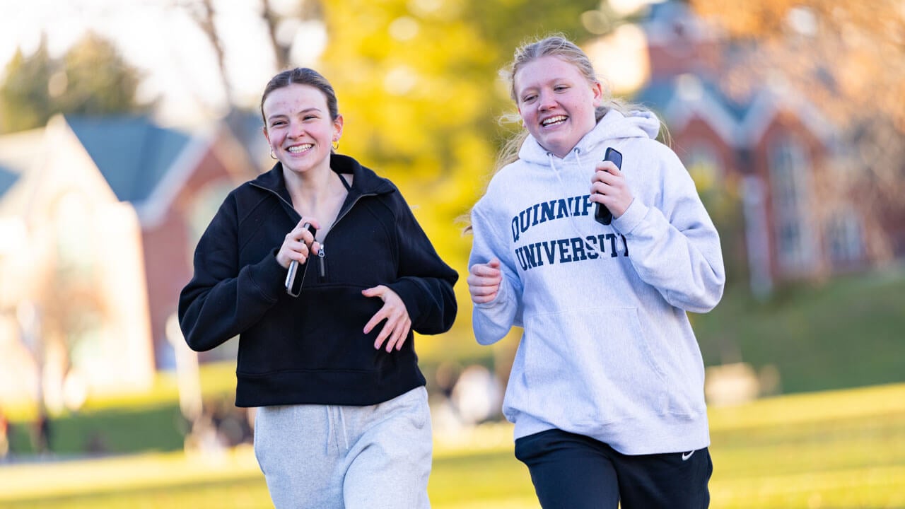 Two participants running the 2025 Jingle Bell Fun Run
