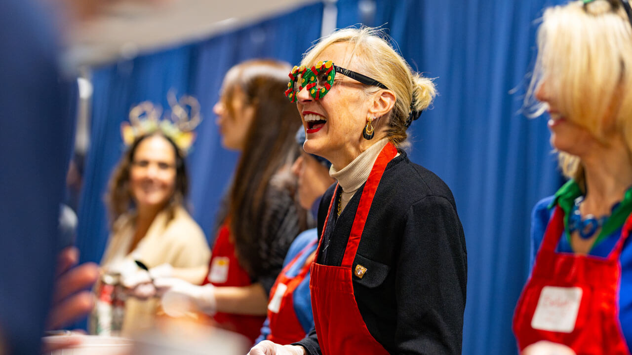 Marie Harden serves holiday dinner to students